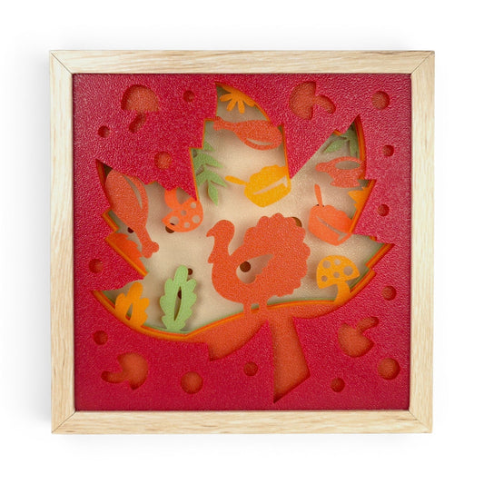 Thanksgiving Leaf Layered Lightbox with turkey, pumpkins, mushrooms, and fall foliage in a light faux-wood frame. Front view of box with led light off.