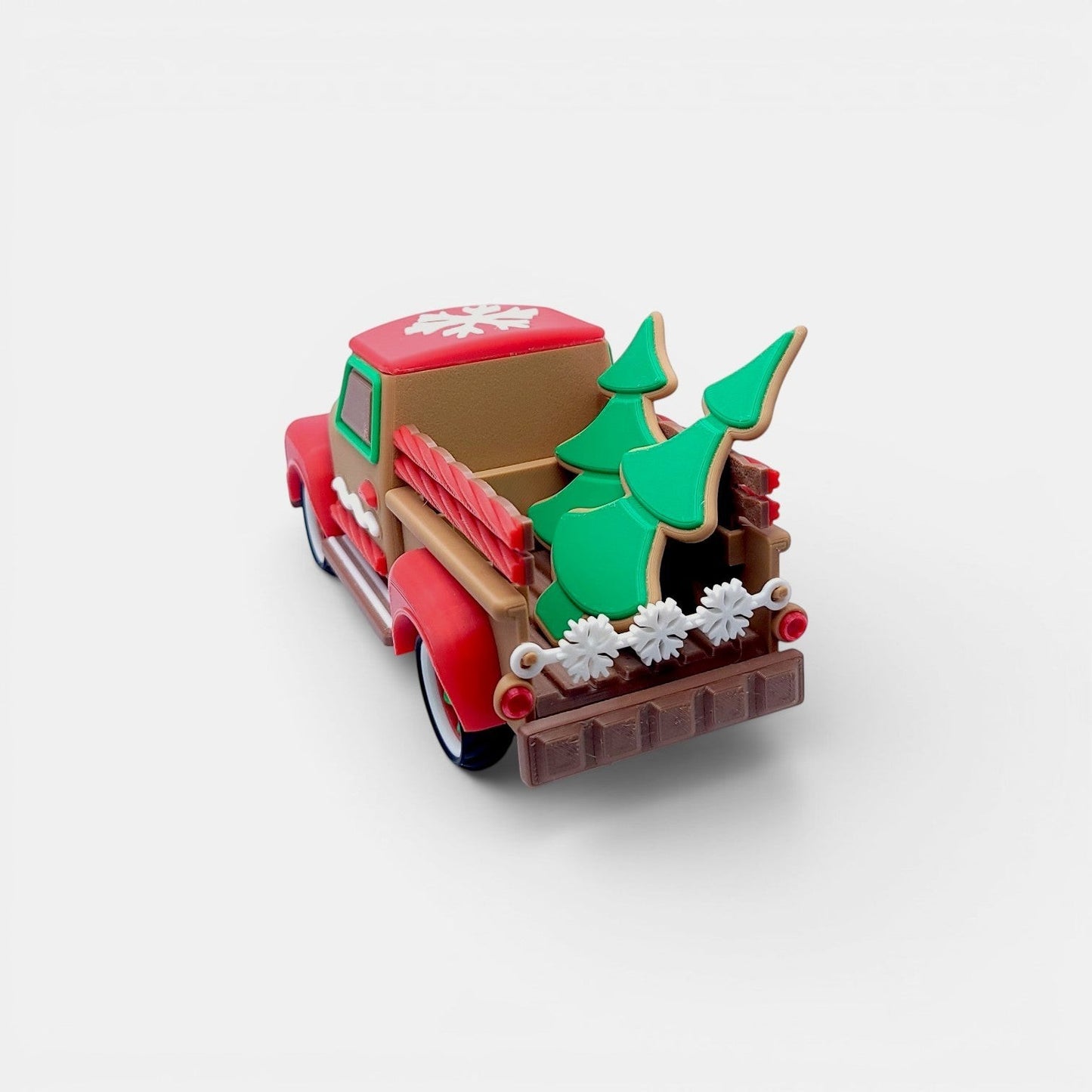 Vintage Christmas truck decoration in tan, red, and green with gingerbread cookie trees and snowflake detail.