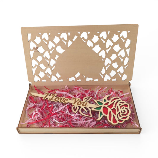 Wooden gift box with laser-cut hearts and a wooden rose inside. The rose has red petals and green leaves with "I Love You" etched on the stem.