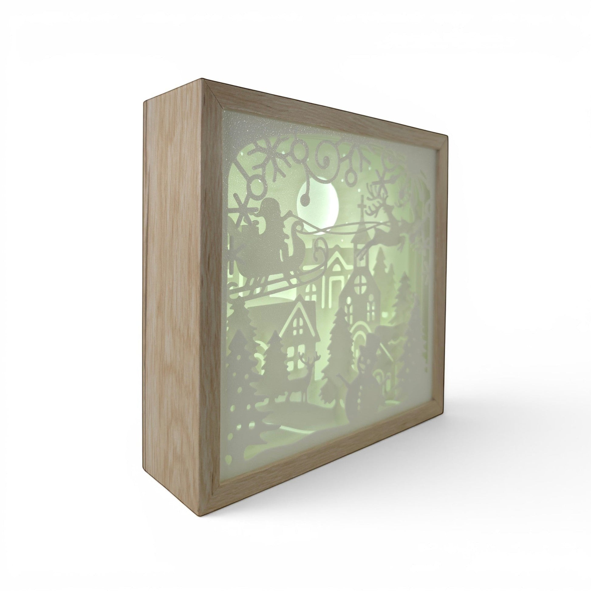 Christmas light box with Santa in sleigh, reindeer, village, and trees. Warm white LED. Illuminated box front left corner.