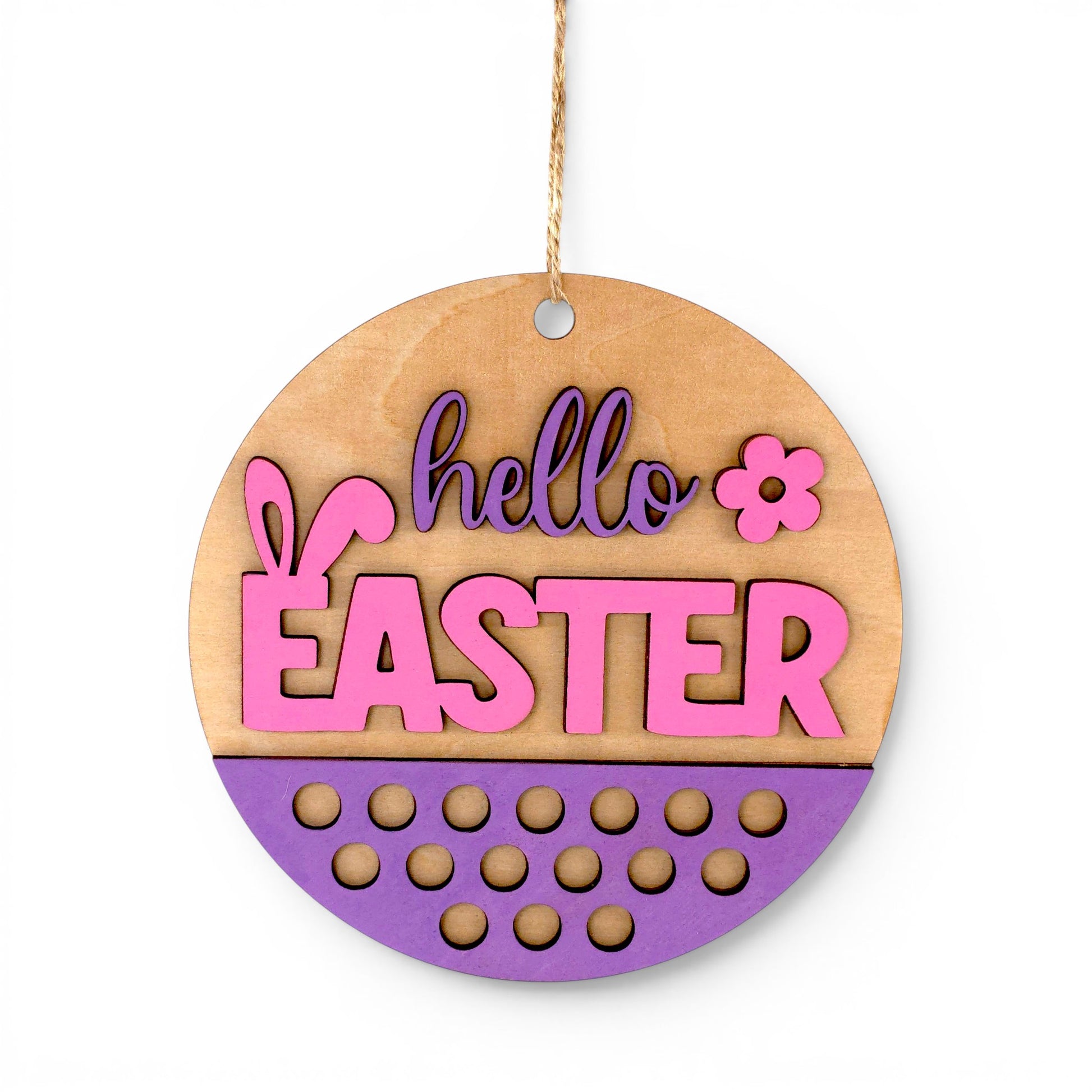 Round Easter Hanging Wood Sign with pink and purple "hello EASTER" lettering, bunny ears, and floral accent. Front view of sign.