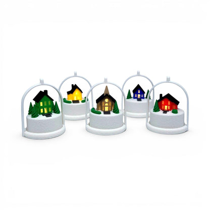 Miniature winter village ornaments with glowing LED houses in arched white frames for holiday decor. Front view of all five houses, in tree stand with light on.