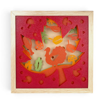 Thanksgiving Leaf Layered Lightbox with turkey, pumpkins, mushrooms, and fall foliage in a light faux-wood frame. Front view of box with led light off.