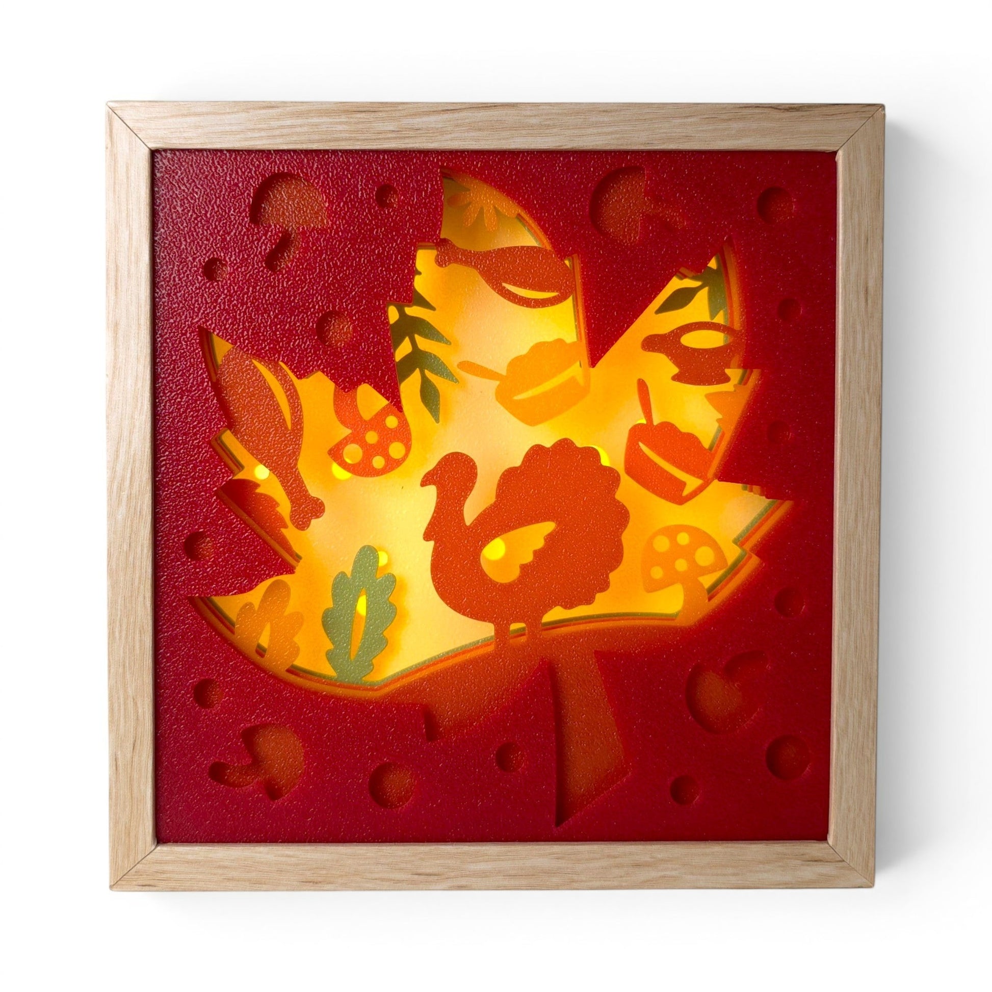 Thanksgiving Leaf Layered Lightbox with turkey, pumpkins, mushrooms, and fall foliage in a light wood frame. Front view of box with led light on.