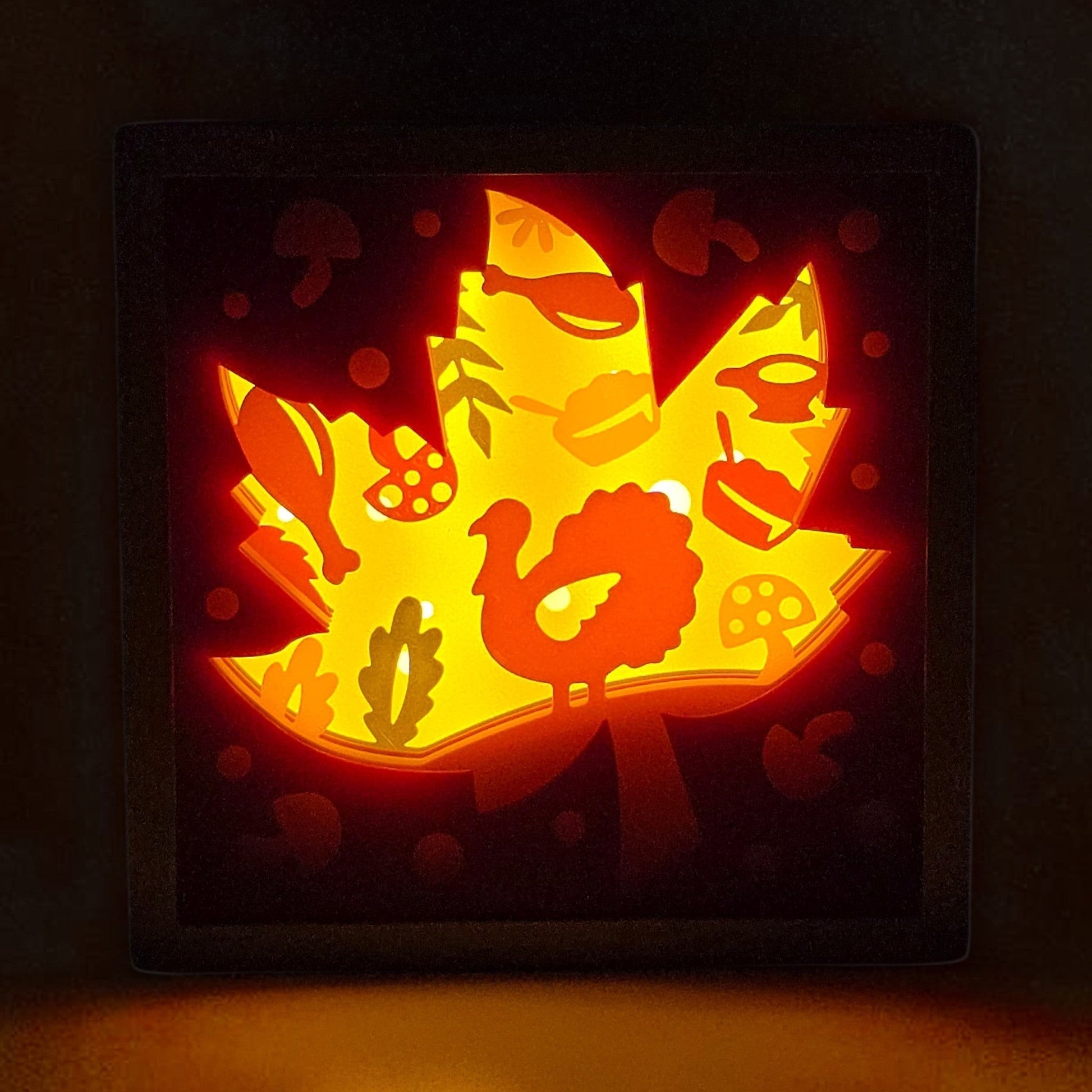 Thanksgiving leaf lightbox with turkey, pumpkins, mushrooms, and fall foliage. Front view with light on with background lights off.