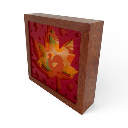 Thanksgiving Leaf Layered Lightbox with turkey, pumpkins, mushrooms, and fall foliage in a natural wood frame. Front right view of box with a dark faux-wood color.