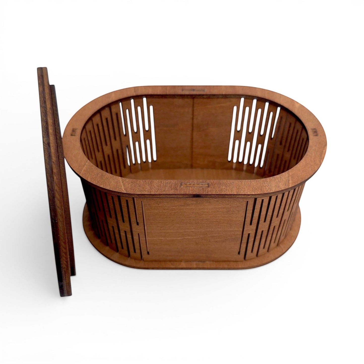 Oval wooden keepsake box with laser-cut slatted sides and matching lid for jewelry storage. Front top view of box with lid off sitting next to the box.