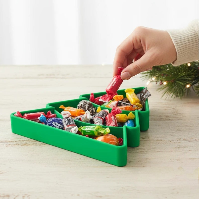 Green Christmas tree candy serving tray with tiered compartments filled with assorted candies.