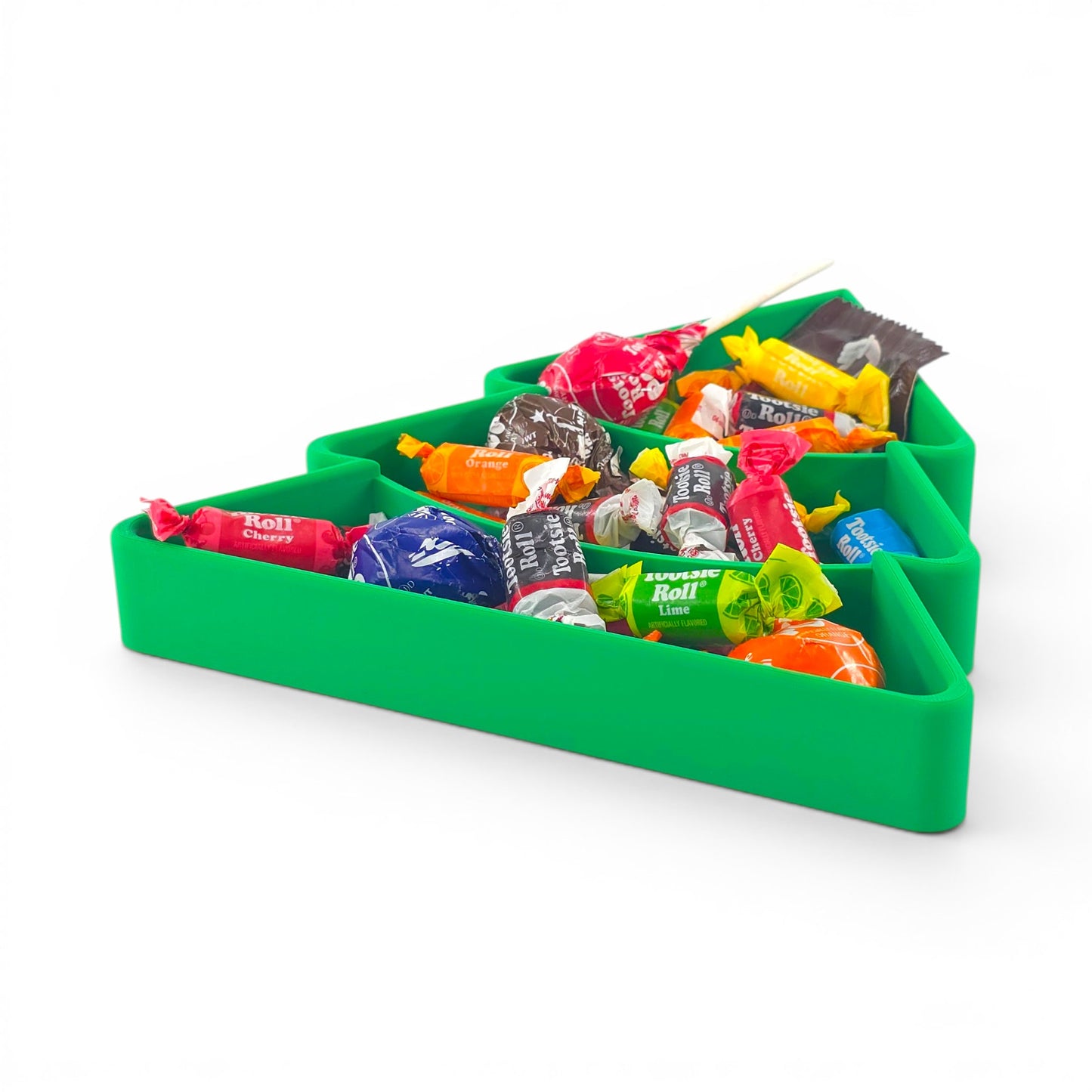Green Christmas tree candy serving tray with multiple compartments filled with assorted wrapped candies. Top angle of tray filled with candy.