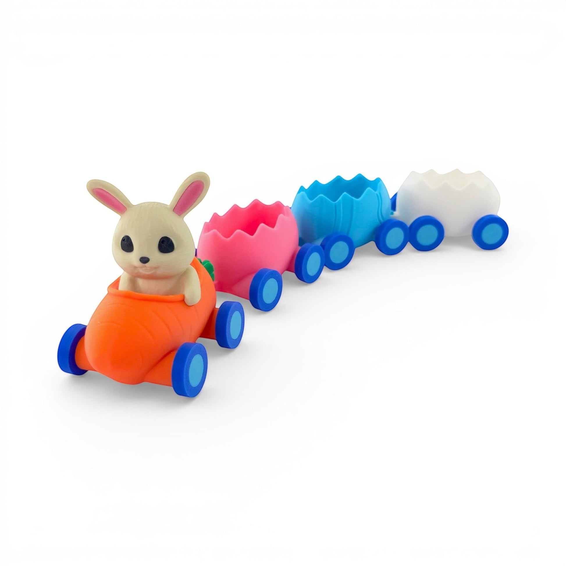 Easter train candy holder with bunny in carrot engine, pink, blue, and white egg carriages. PLA plastic. Front left side view of train with no candy.