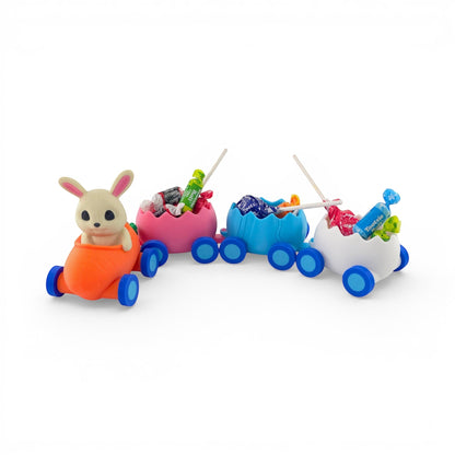 Easter Train Candy Holder with bunny in carrot engine, pink, blue, white egg carriages filled with candy. Left view of train with candy inside.