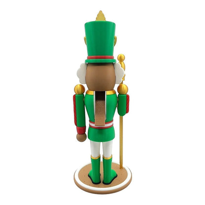 Green nutcracker decoration with gold accents and a candy cane detail on its hat.