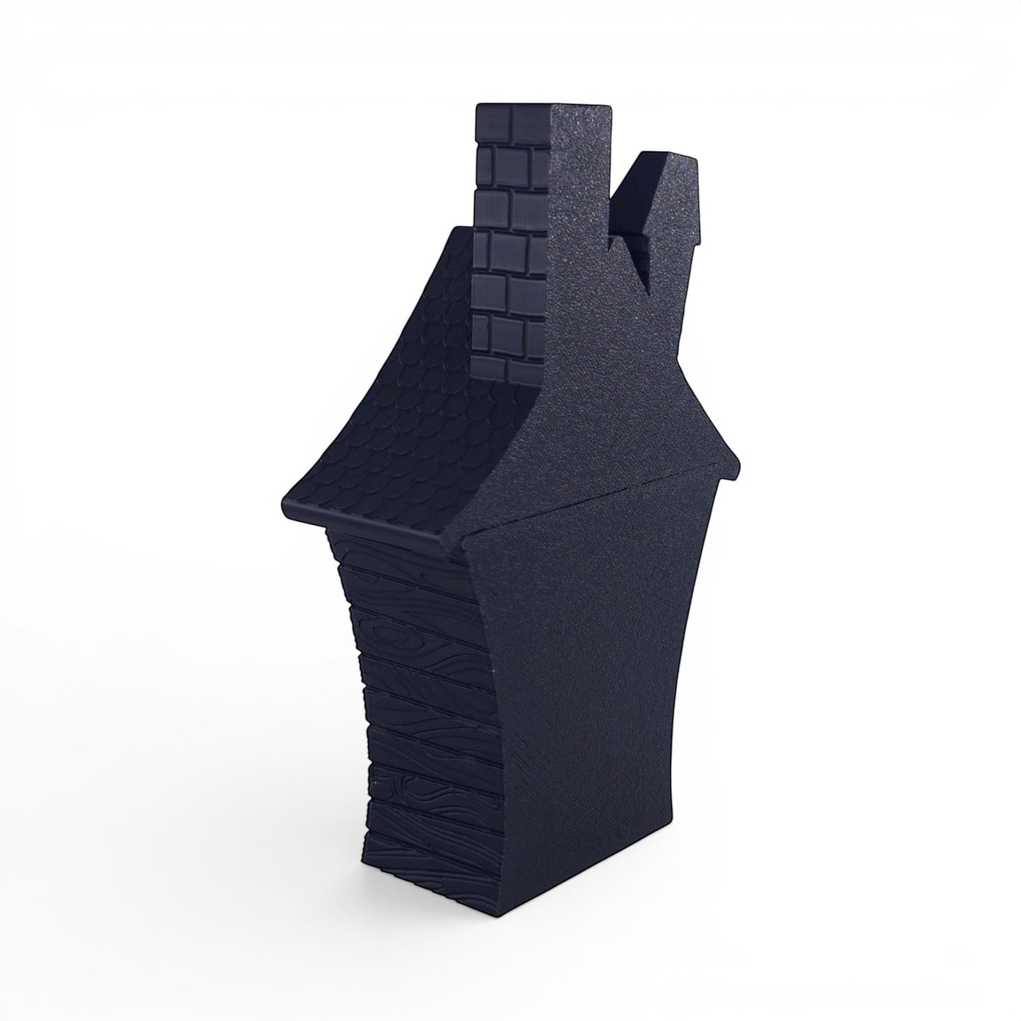 Black PLA flickering haunted house decoration with brick chimney and wood-textured walls. Back right corner of house.