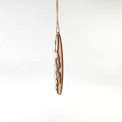 He Lives Easter wooden ornament with cross, lilies, and dove. Natural wood finish.