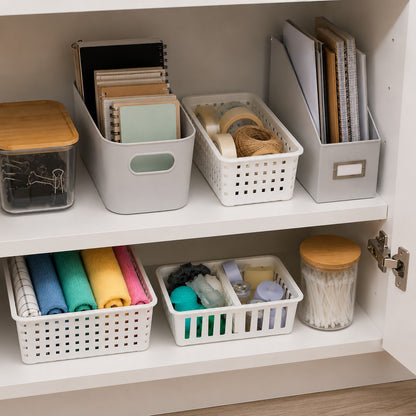 honeycomb storage basket dividers organizing toiletries and craft supplies inside a white cabinet.