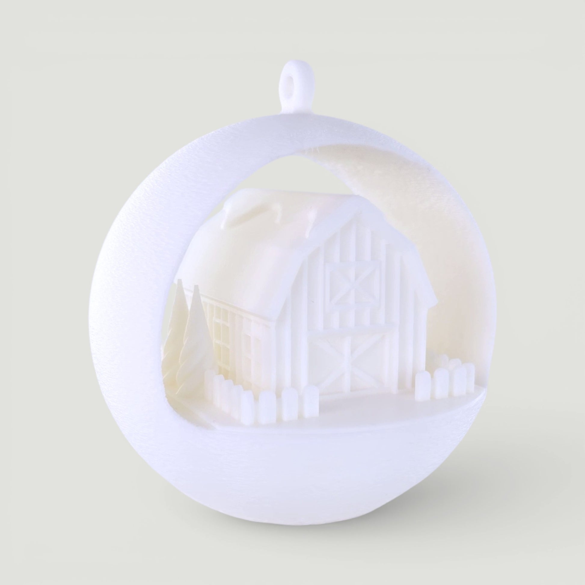 illuminated white barn ornament with miniature trees and picket fence, PLA plastic, rustic winter scene. Light off, rear left corner of ornament.