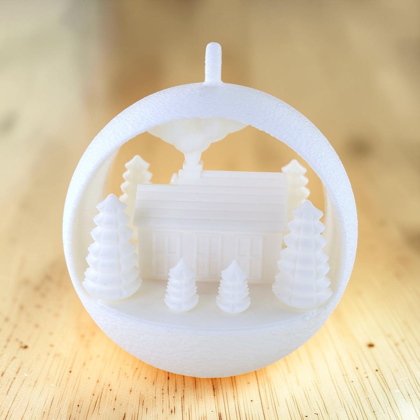 white PLA illuminated winter farmhouse ornament with evergreen trees and fence. Light off, back of ornament.