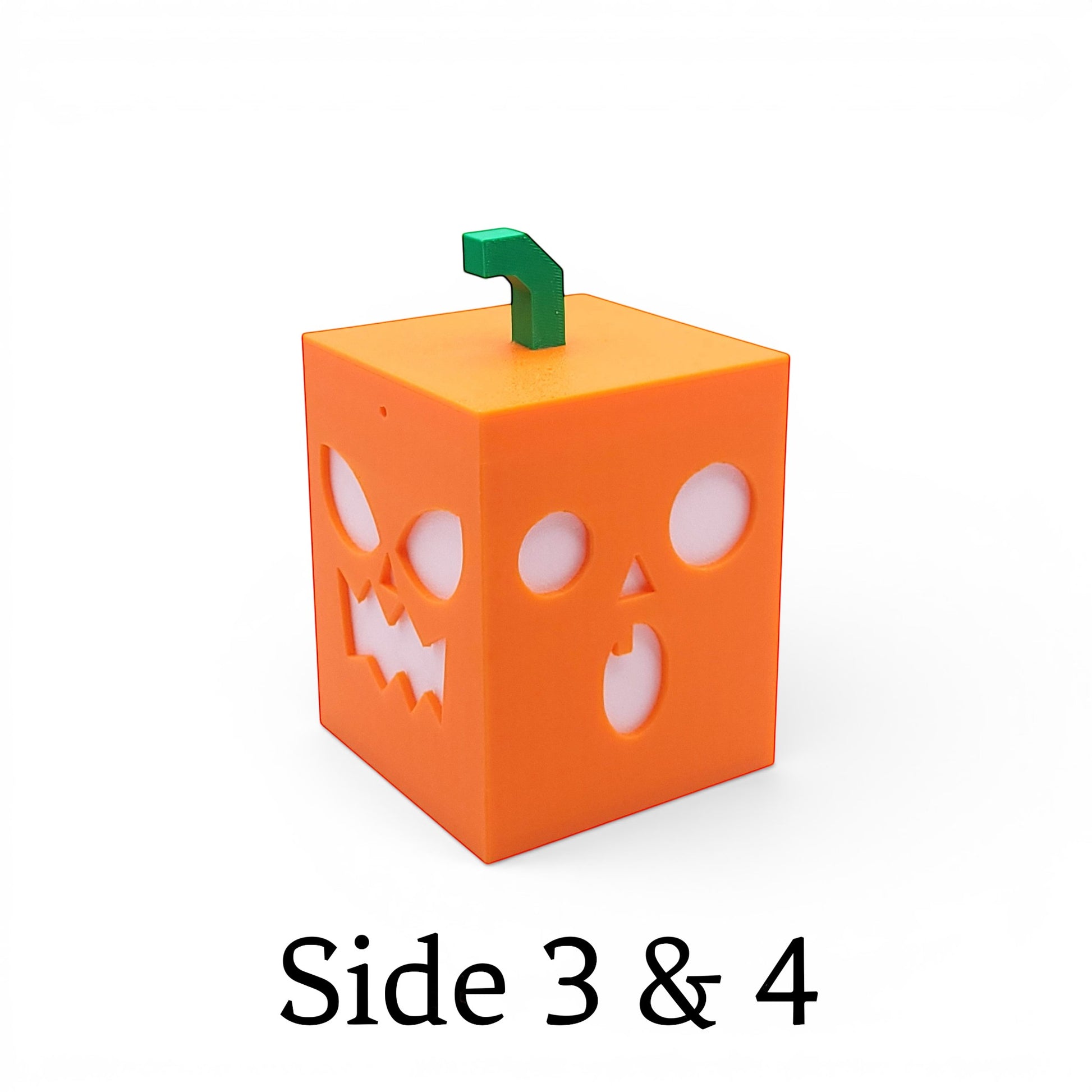 Orange PLA cube light with playful jack-o-lantern faces and green stem.