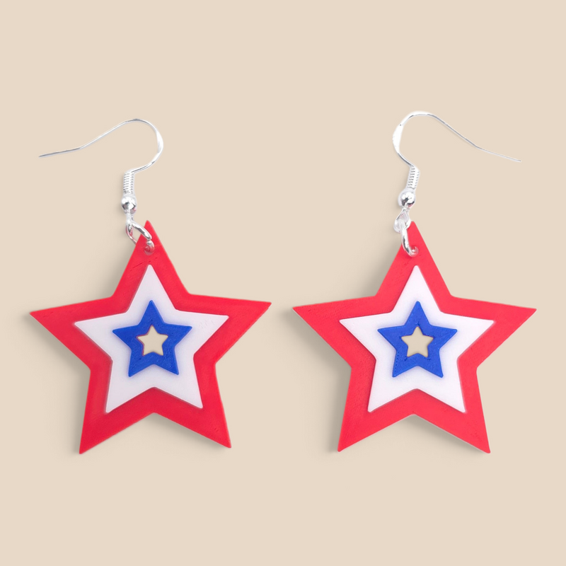 layered star dangle earrings in red, white, and blue with a festive patriotic design.