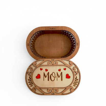 wooden keepsake box for Mom with laser-cut scrollwork and hand-painted red heart accents. Looking inside of box from top down.