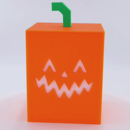 Rotating Illuminated Jack O Lantern Cube Light. First half with LED flickering tealight off. Second half with LED flickering tealight on. 