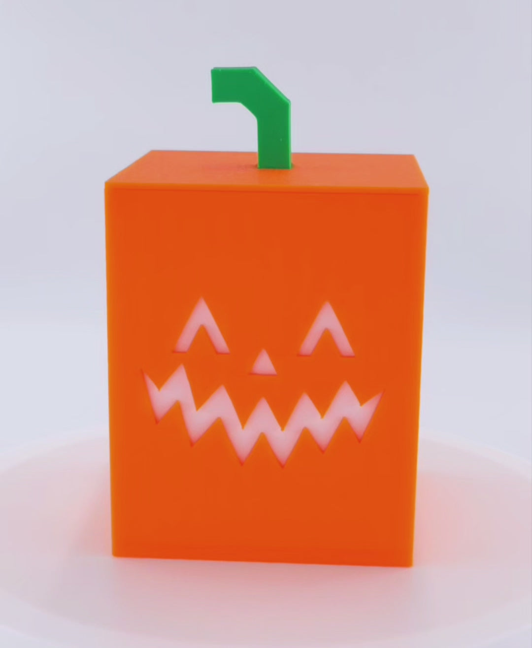Rotating Illuminated Jack O Lantern Cube Light. First half with LED flickering tealight off. Second half with LED flickering tealight on. 