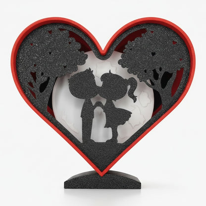 Valentines Heart Light Box with couple silhouette, trees, and moon. Red frame.
