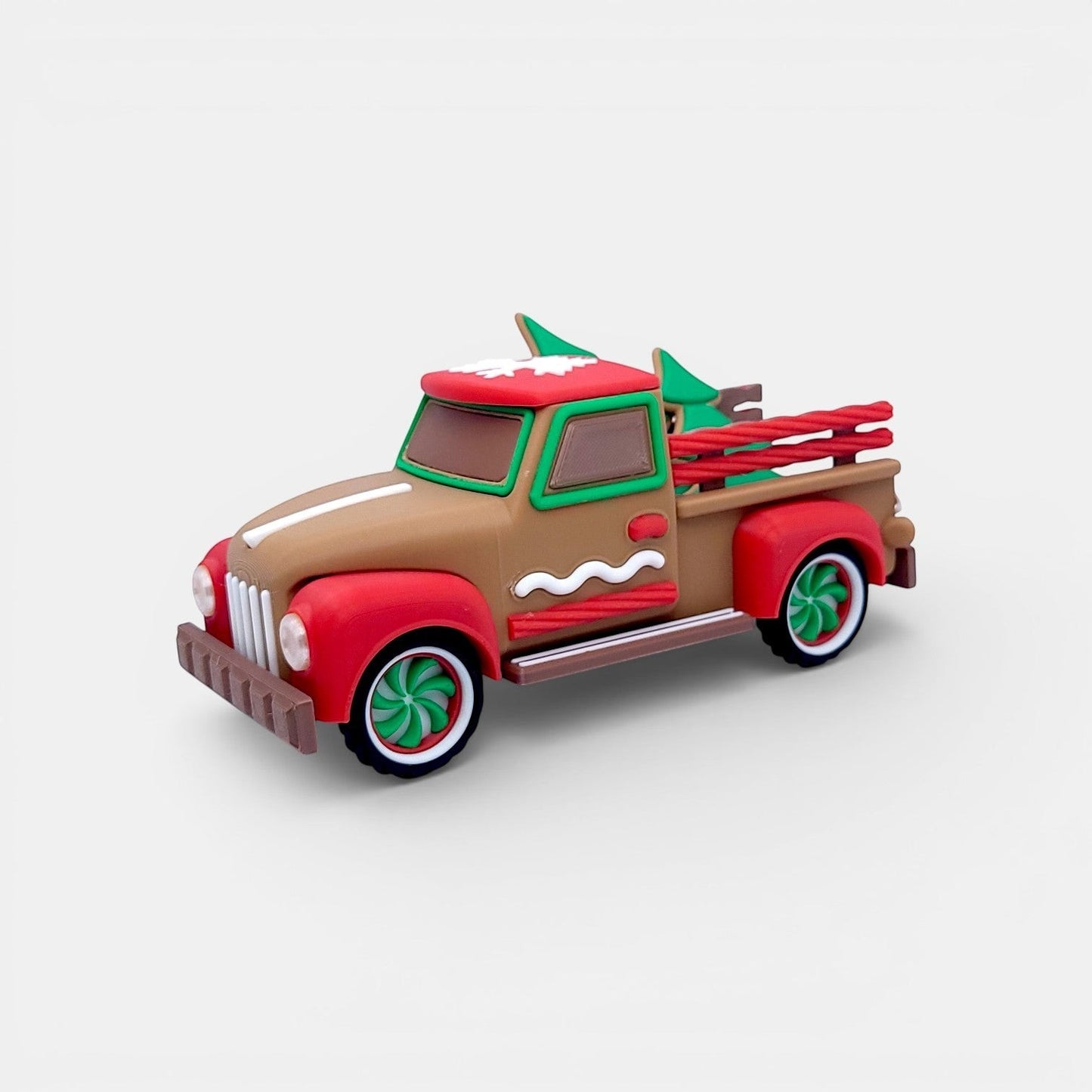 Vintage Christmas truck decoration in tan, red, and green with gingerbread accents and miniature trees.