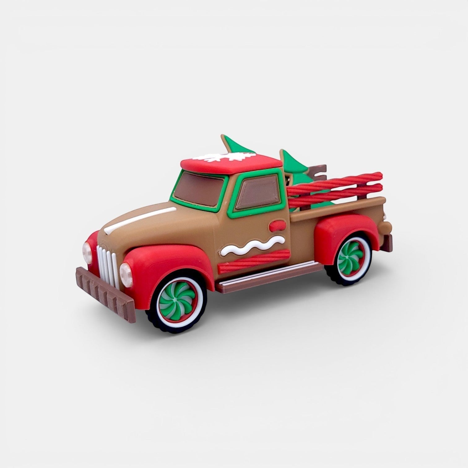 Vintage Christmas truck decoration in tan, red, and green with gingerbread accents and miniature trees.