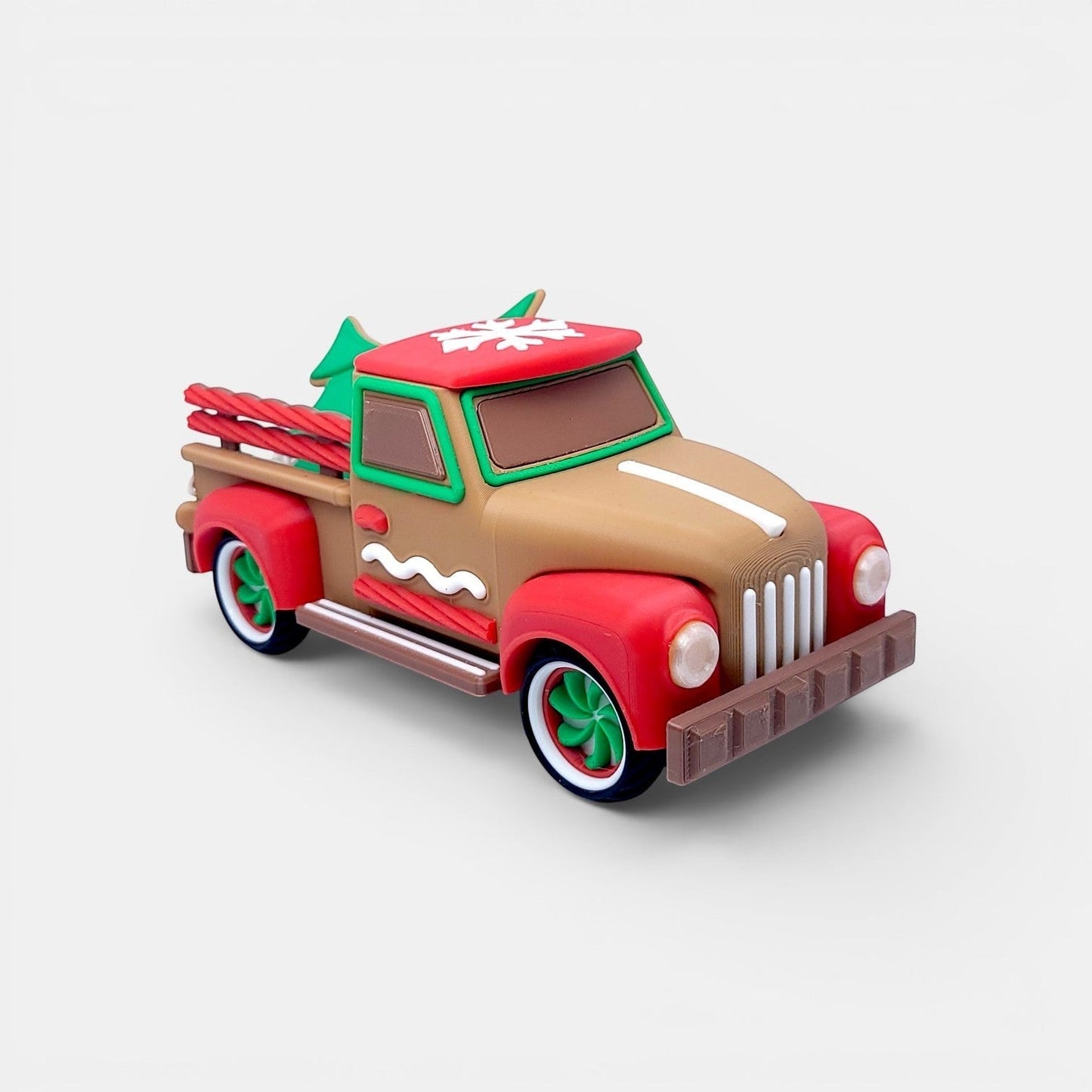 Vintage Christmas truck decoration in tan, red, and green with gingerbread accents and miniature trees.