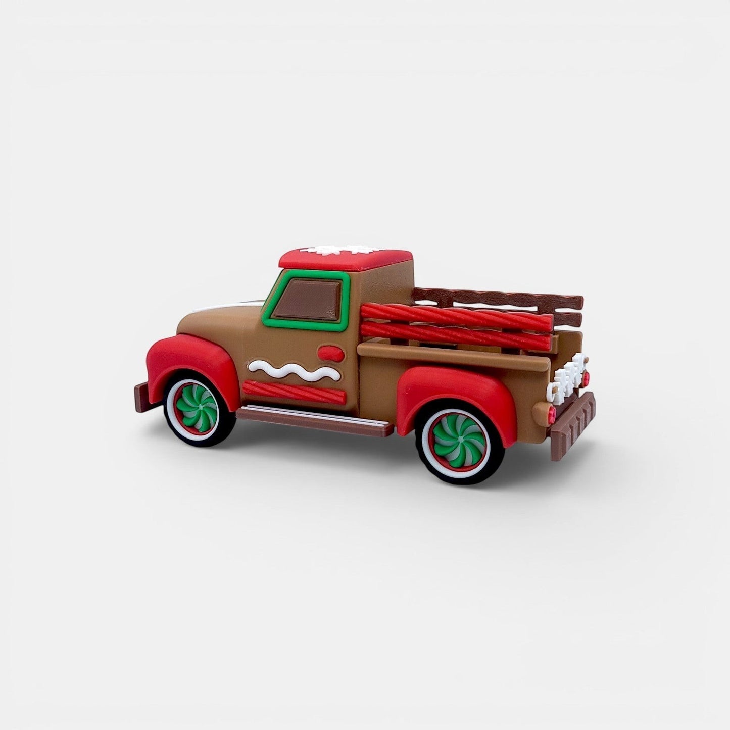 Vintage Christmas truck decoration in tan, red, and green with gingerbread accents and white snowflake detail on roof.